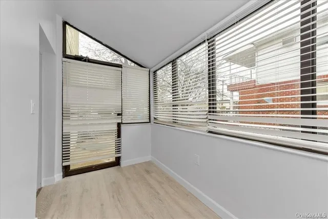 a view of wooden floor and windows in a room