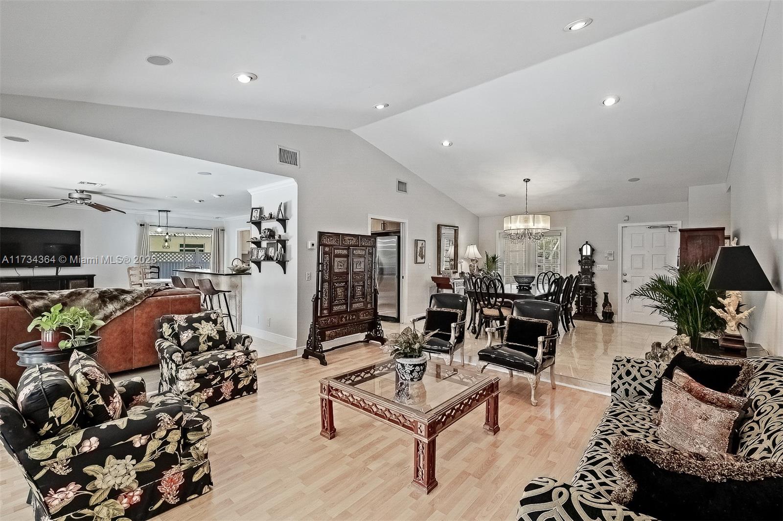 7260 Northwest 4th Avenue Boca Raton, FL 33487 - Photo 14 of 59 a living room with lots of furniture and gym equipment