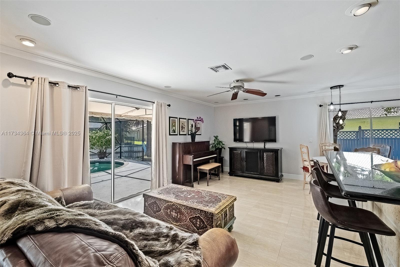 7260 Northwest 4th Avenue Boca Raton, FL 33487 - Photo 16 of 59 a bedroom with furniture and a flat screen tv