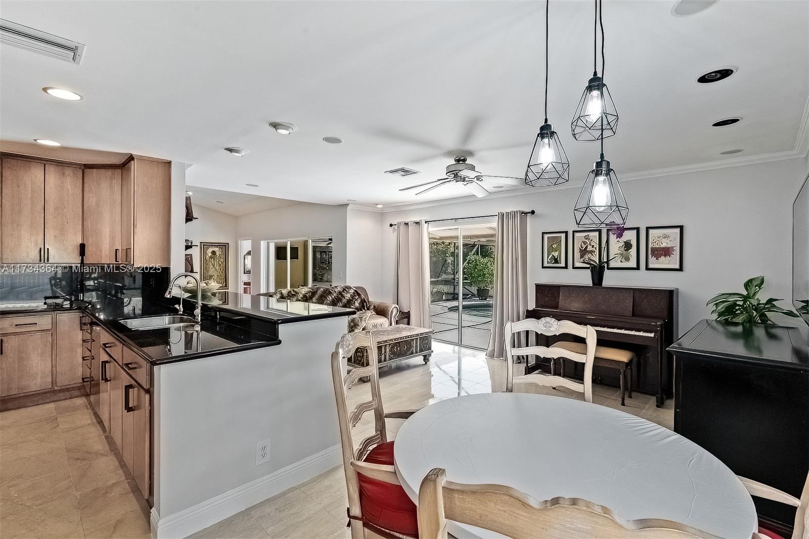 7260 Northwest 4th Avenue Boca Raton, FL 33487 - Photo 17 of 59 a view of a dining room and livingroom with furniture wooden floor a chandelier