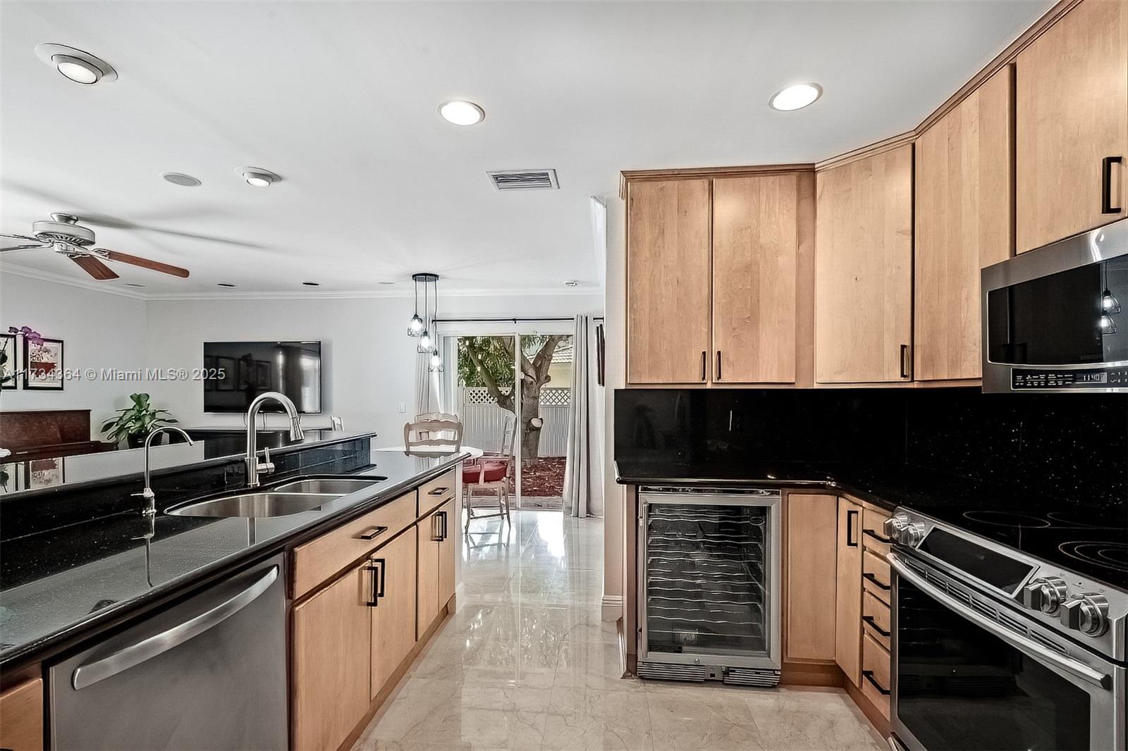 7260 Northwest 4th Avenue Boca Raton, FL 33487 - Photo 21 of 59 a kitchen with stainless steel appliances a stove sink and microwave