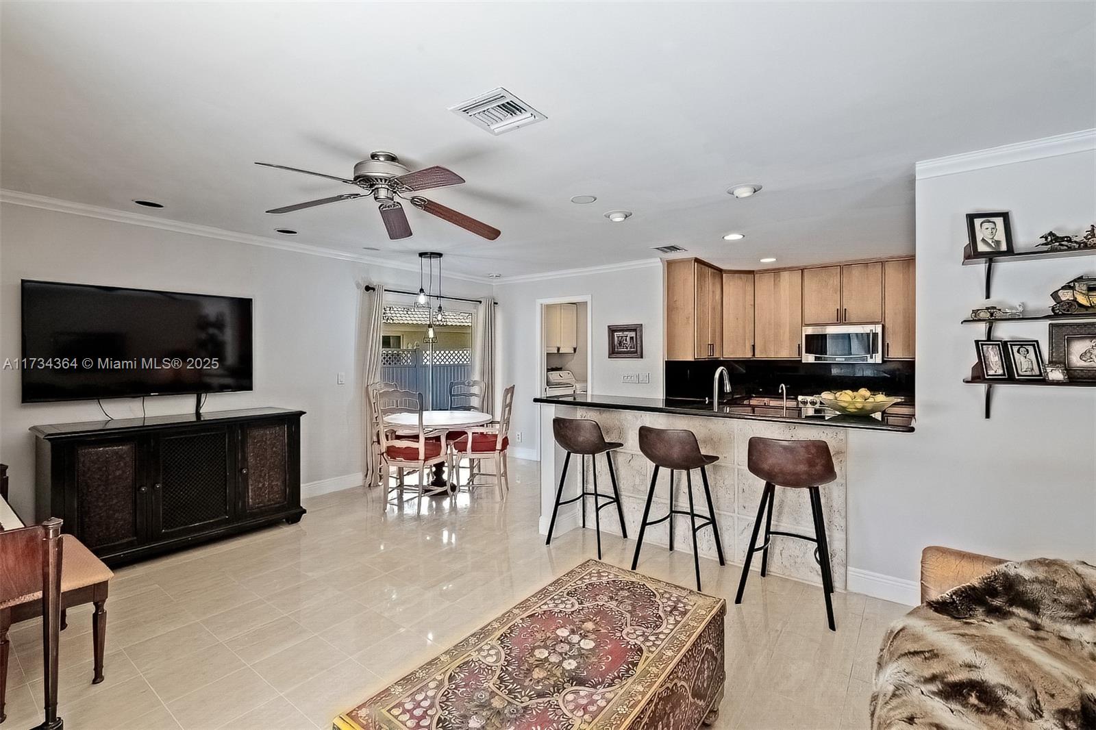 7260 Northwest 4th Avenue Boca Raton, FL 33487 - Photo 24 of 59 a living room with furniture and a flat screen tv