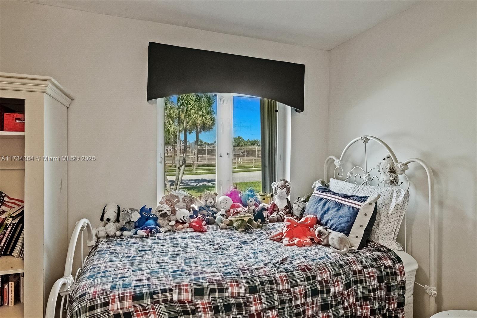 7260 Northwest 4th Avenue Boca Raton, FL 33487 - Photo 28 of 59 a bedroom with a bed and a window