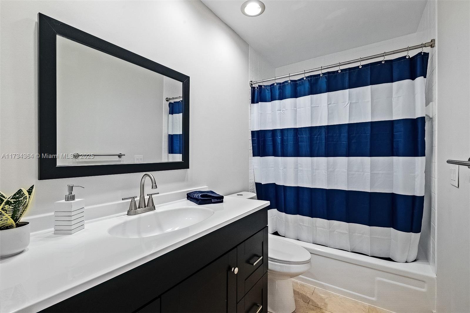 7260 Northwest 4th Avenue Boca Raton, FL 33487 - Photo 32 of 59 a bathroom with a sink a toilet and a mirror