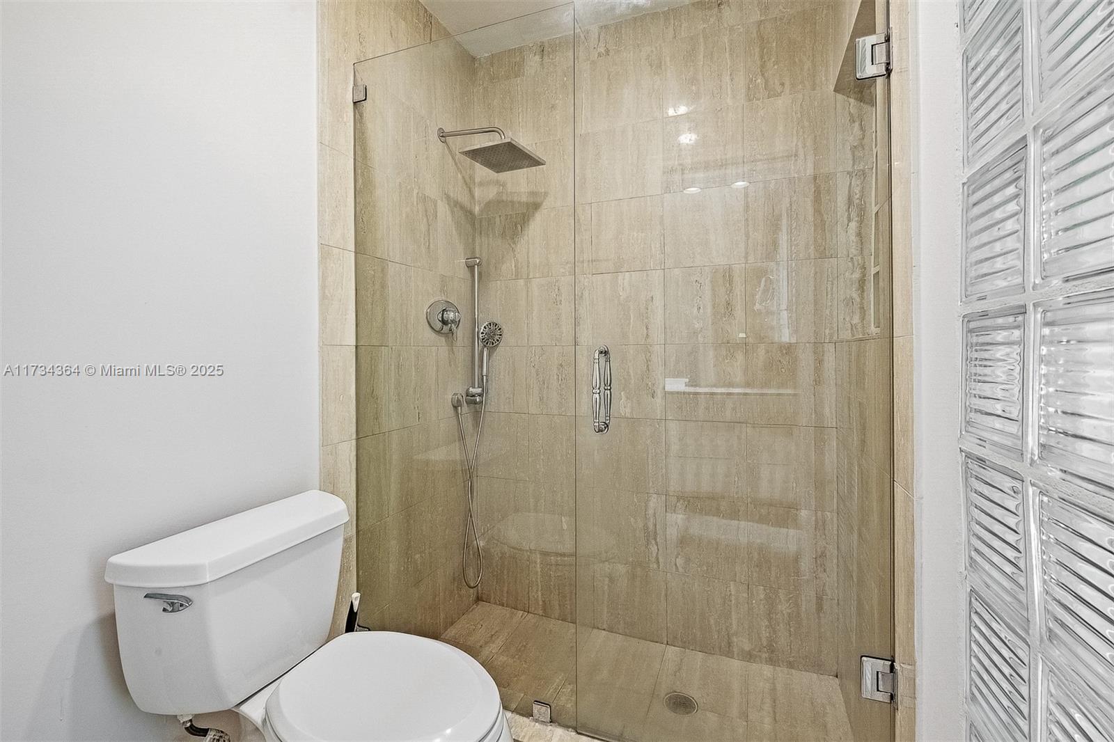 7260 Northwest 4th Avenue Boca Raton, FL 33487 - Photo 34 of 59 a white toilet sitting next to a bathroom sink