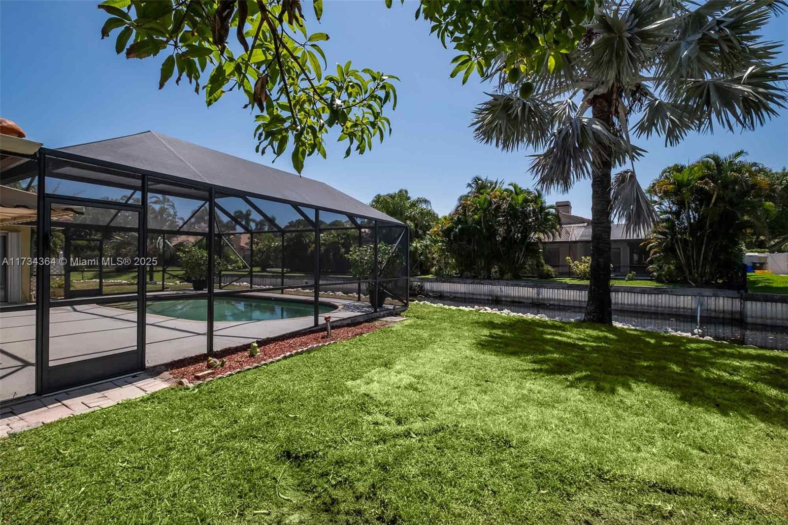 7260 Northwest 4th Avenue Boca Raton, FL 33487 - Photo 44 of 59 a view of a backyard with a garden and swimming pool
