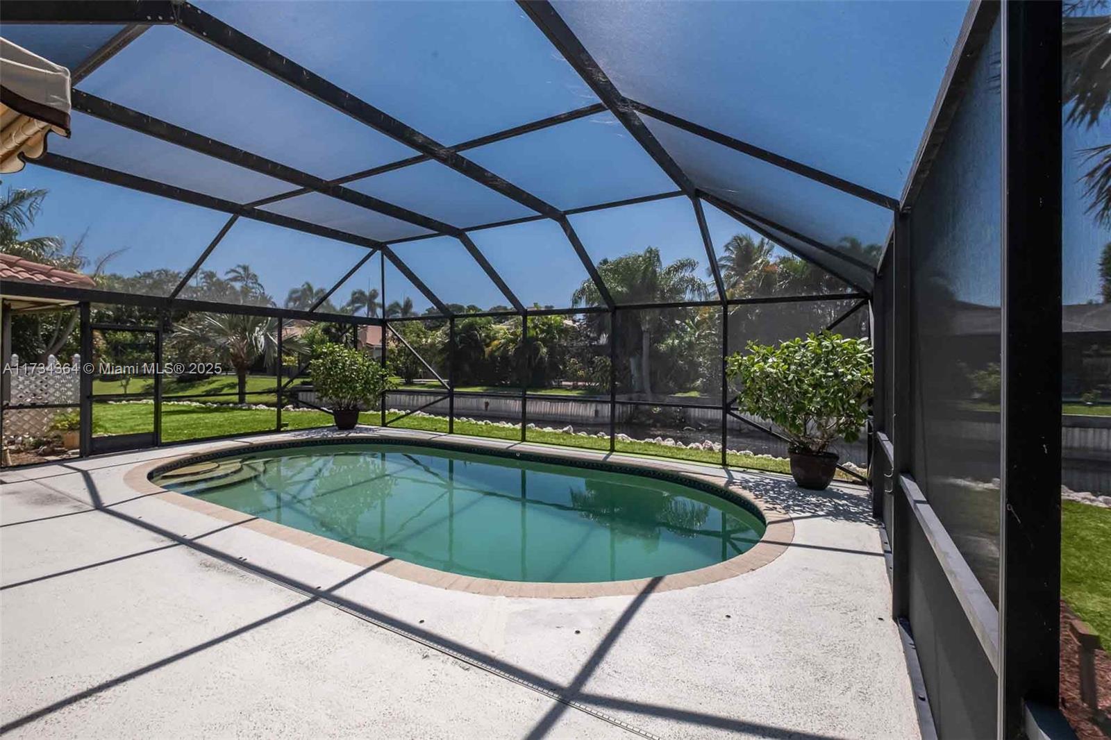 7260 Northwest 4th Avenue Boca Raton, FL 33487 - Photo 47 of 59 a view of a swimming pool with a porch