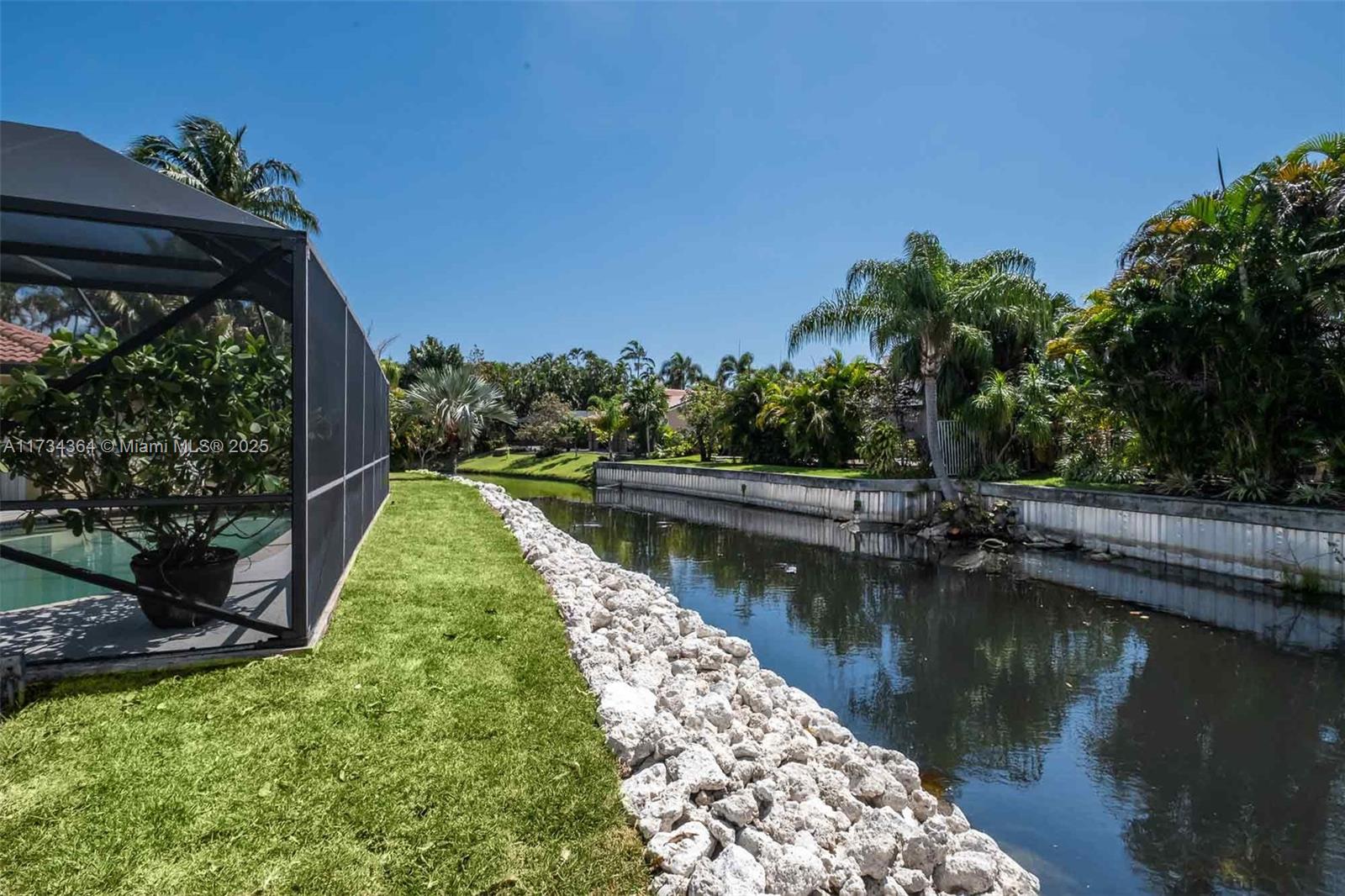 7260 Northwest 4th Avenue Boca Raton, FL 33487 - Photo 49 of 59 a view of a lake with a house in the background