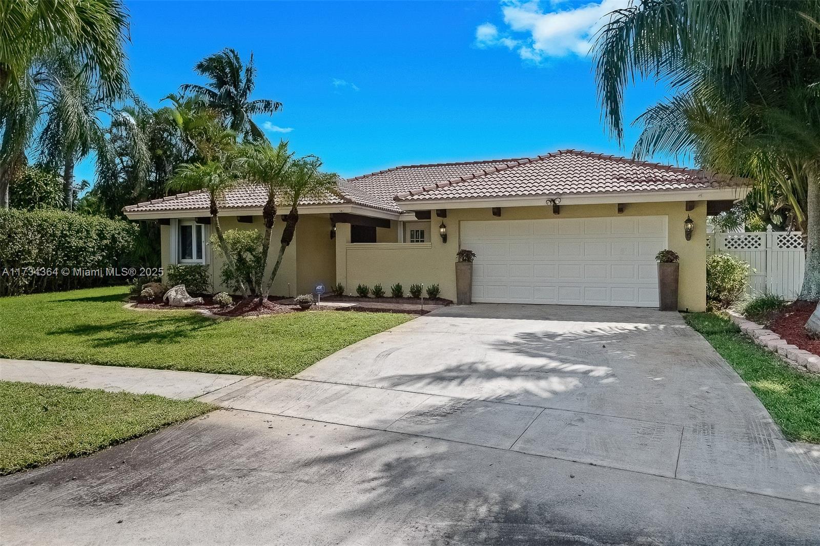 7260 Northwest 4th Avenue Boca Raton, FL 33487 - Photo 5 of 59 a front view of a house with garden