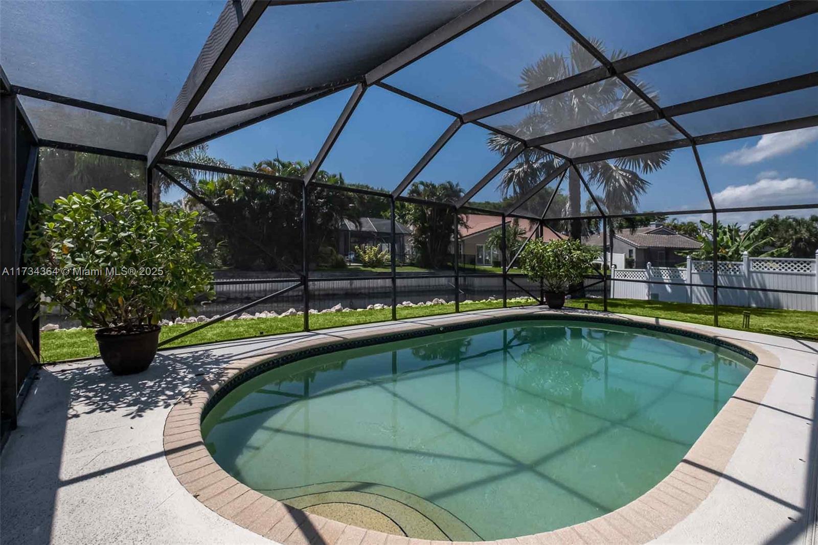 7260 Northwest 4th Avenue Boca Raton, FL 33487 - Photo 55 of 59 a view of a swimming pool with a patio
