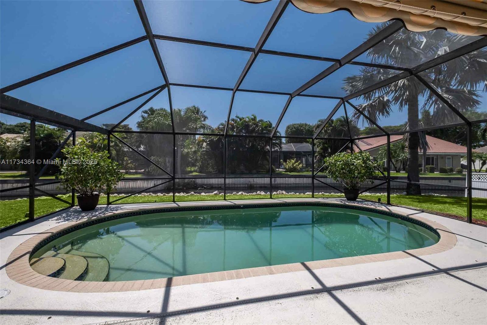 7260 Northwest 4th Avenue Boca Raton, FL 33487 - Photo 59 of 59 a view of a swimming pool with a patio