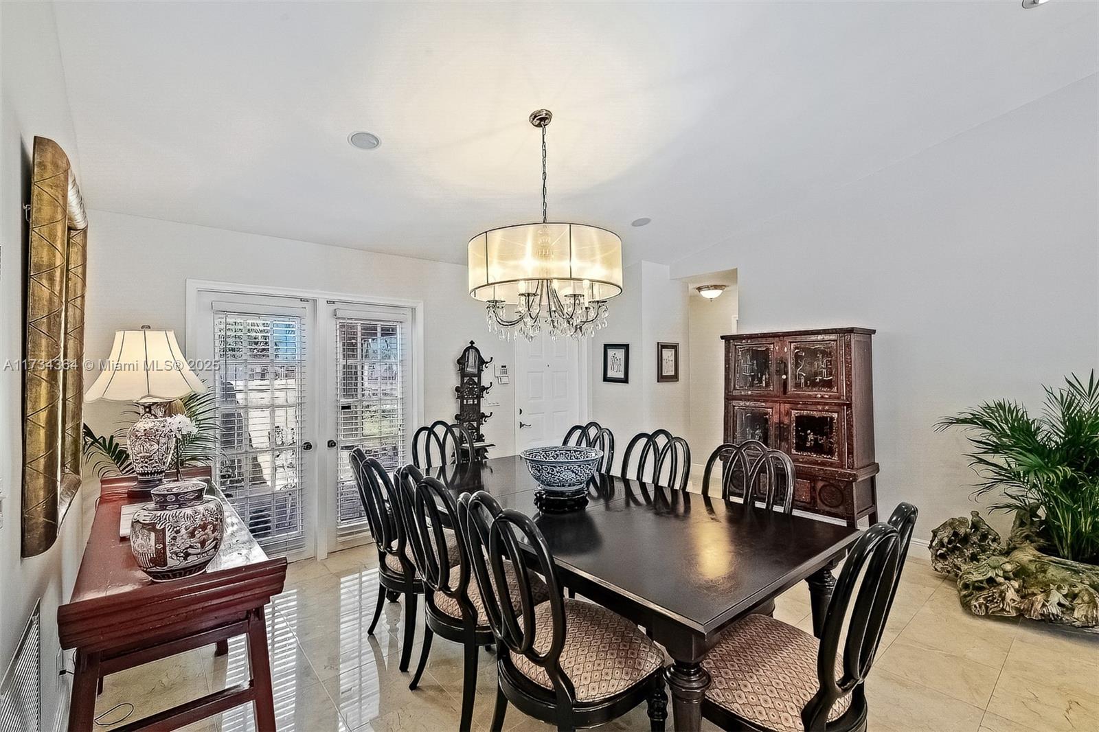 7260 Northwest 4th Avenue Boca Raton, FL 33487 - Photo 9 of 59 a view of a dining room with furniture window and wooden floor