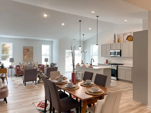 a large kitchen with a table and chairs