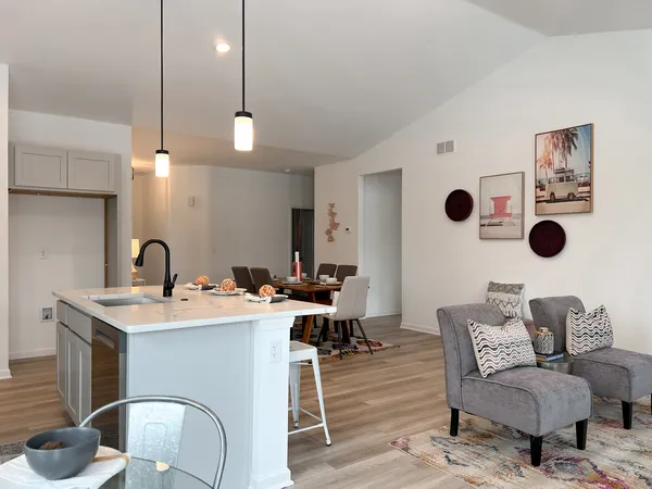 a living room with furniture and wooden floor