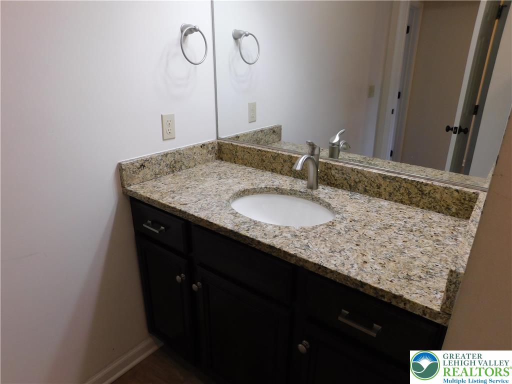 821 Masslich Street Bethlehem, PA 18018 - Photo 16 of 23 a bathroom with a granite countertop sink and a mirror