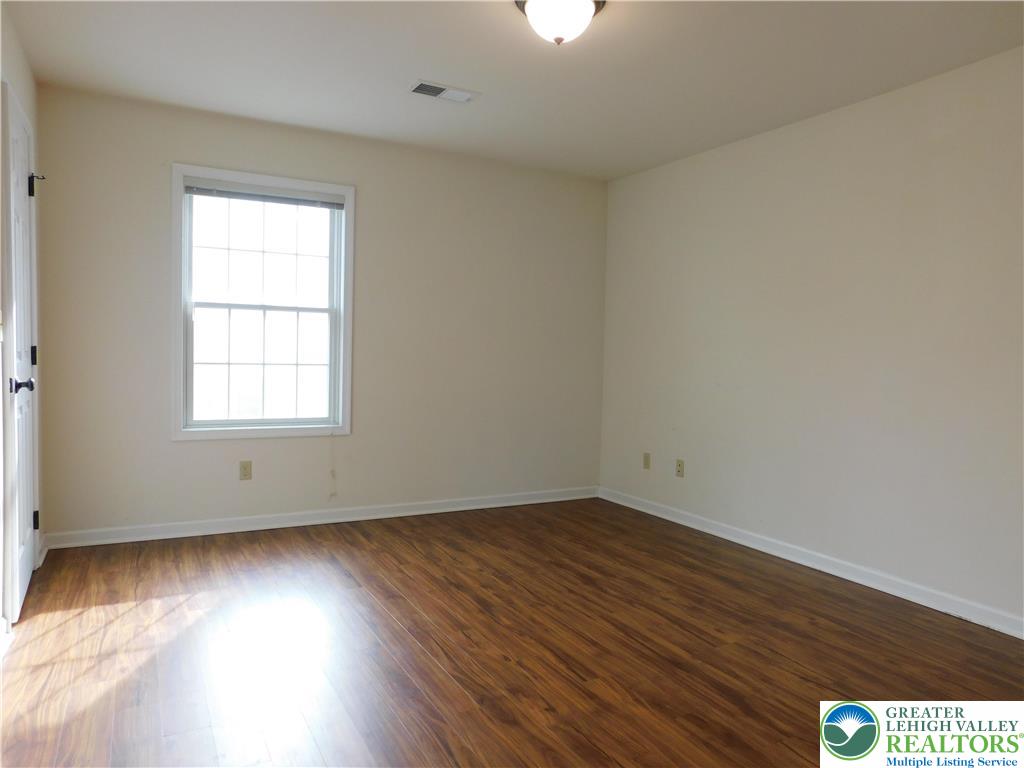 821 Masslich Street Bethlehem, PA 18018 - Photo 19 of 23 an empty room with wooden floor and windows