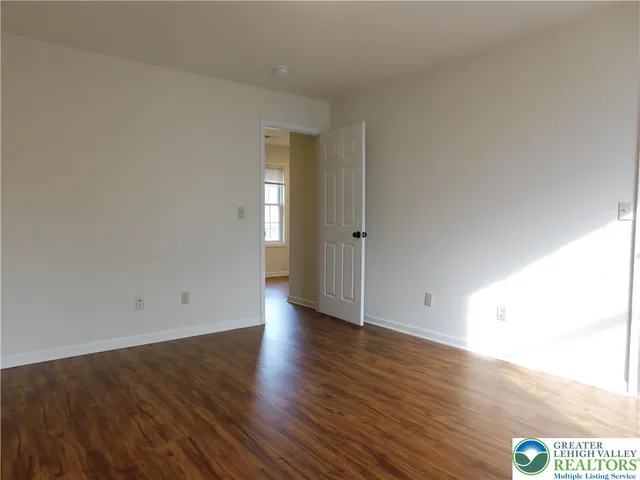 an empty room with wooden floor