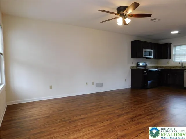 a view of a kitchen with a sink and a microwave