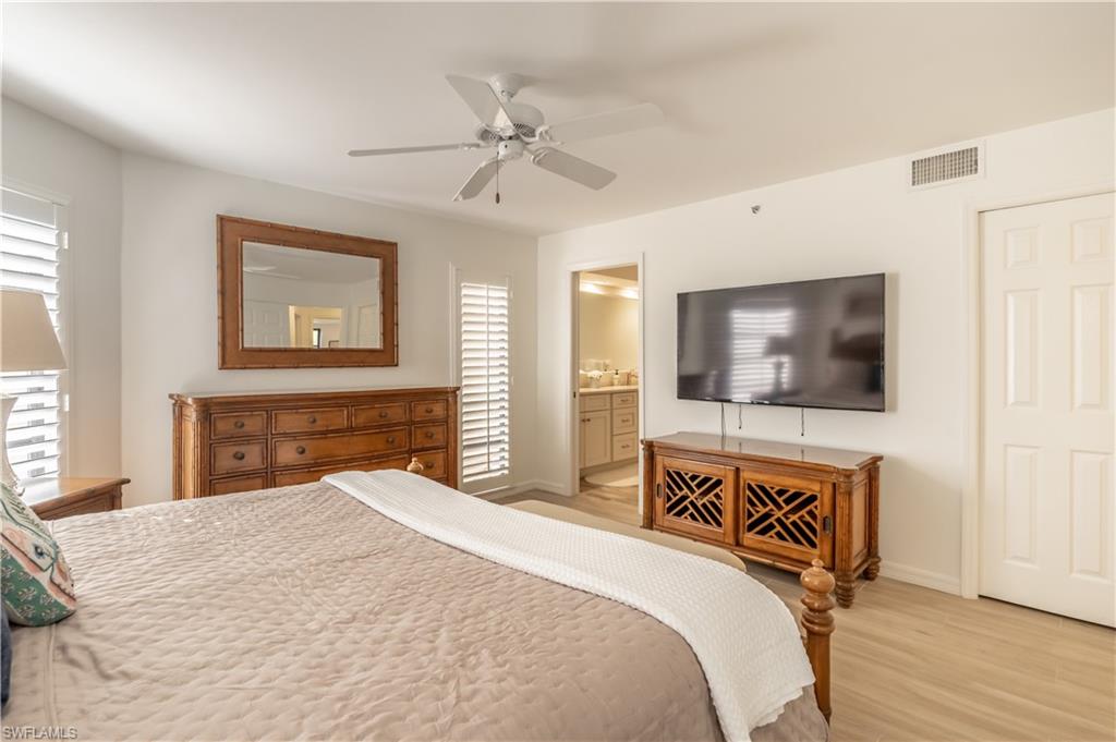 651 10th Avenue South, Unit C651 Naples, FL 34102 - Photo 13 of 32 a bedroom with a bed and a flat screen tv