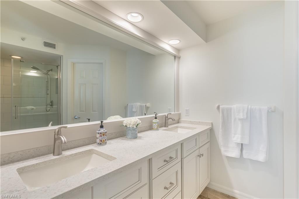 651 10th Avenue South, Unit C651 Naples, FL 34102 - Photo 15 of 32 a bathroom with 2 sink tub and a mirror