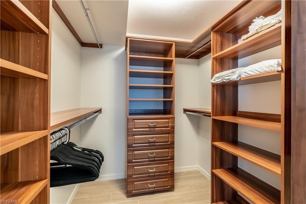 651 10th Avenue South, Unit C651 Naples, FL 34102 - Photo 20 of 32 a view of walk in closet with clothes and shoes