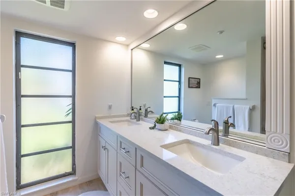 a bathroom with a double vanity sink and a mirror