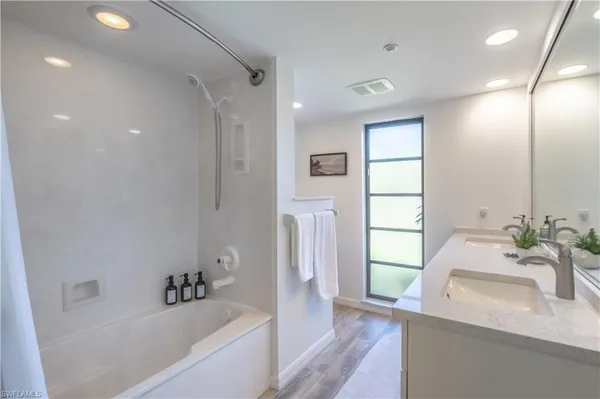 a bathroom with a bathtub and a sink