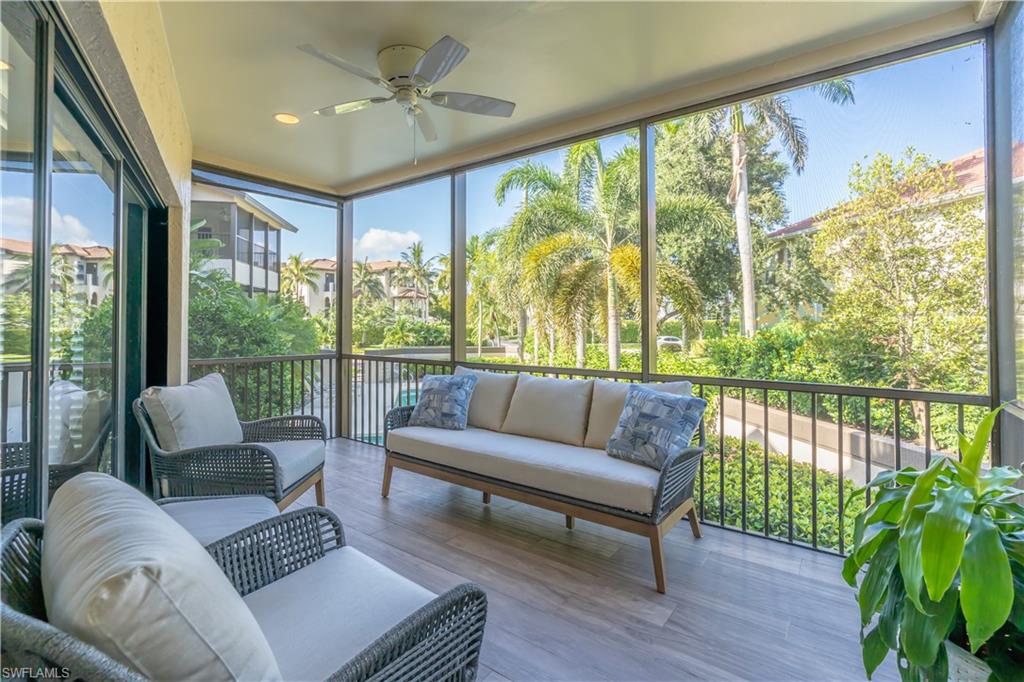 651 10th Avenue South, Unit C651 Naples, FL 34102 - Photo 24 of 32 a living room with furniture and a floor to ceiling window