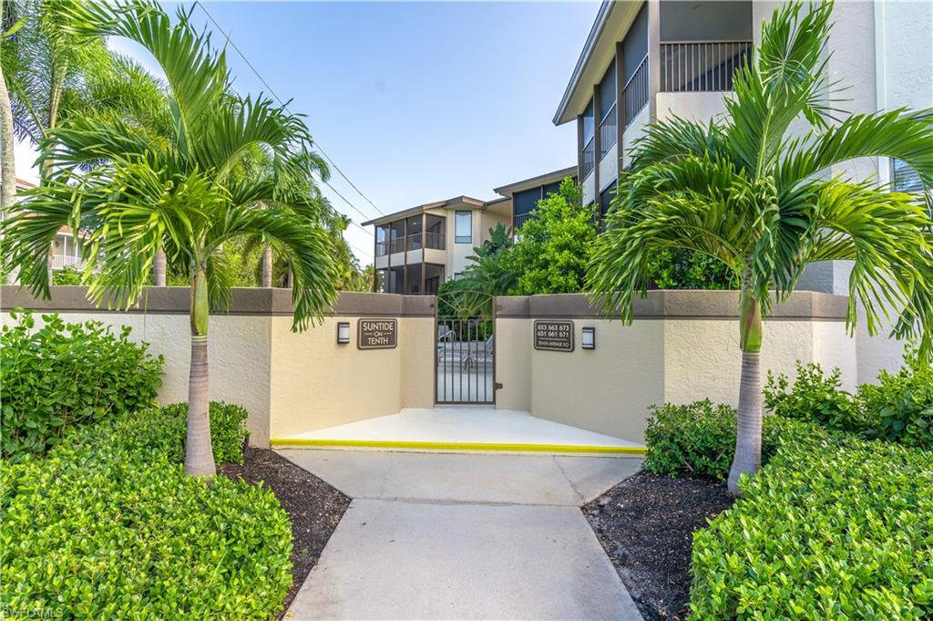651 10th Avenue South, Unit C651 Naples, FL 34102 - Photo 26 of 32 a view of a swimming pool with a yard and plants