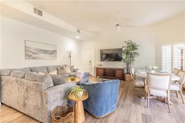 a living room with furniture wooden floor and a fireplace