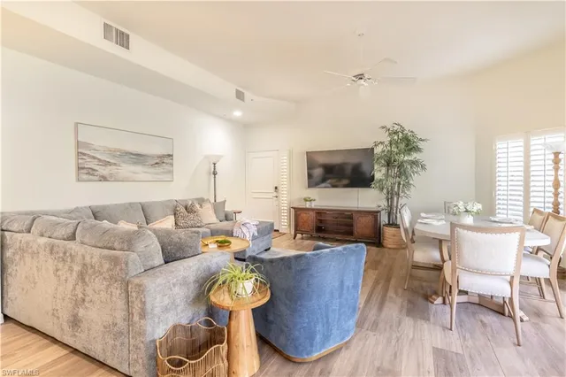 a living room with furniture wooden floor and a fireplace