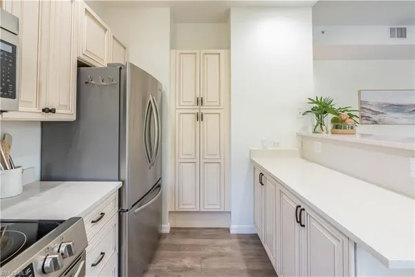 a kitchen with a refrigerator and a sink