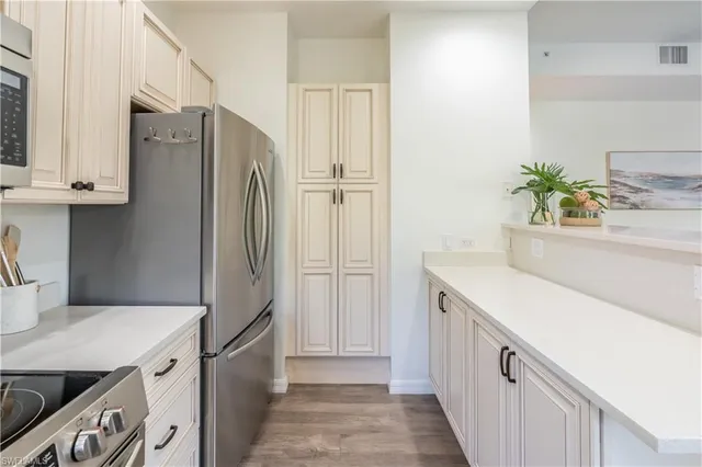 a kitchen with a refrigerator and a sink