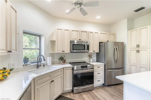 a kitchen with a sink stove and refrigerator