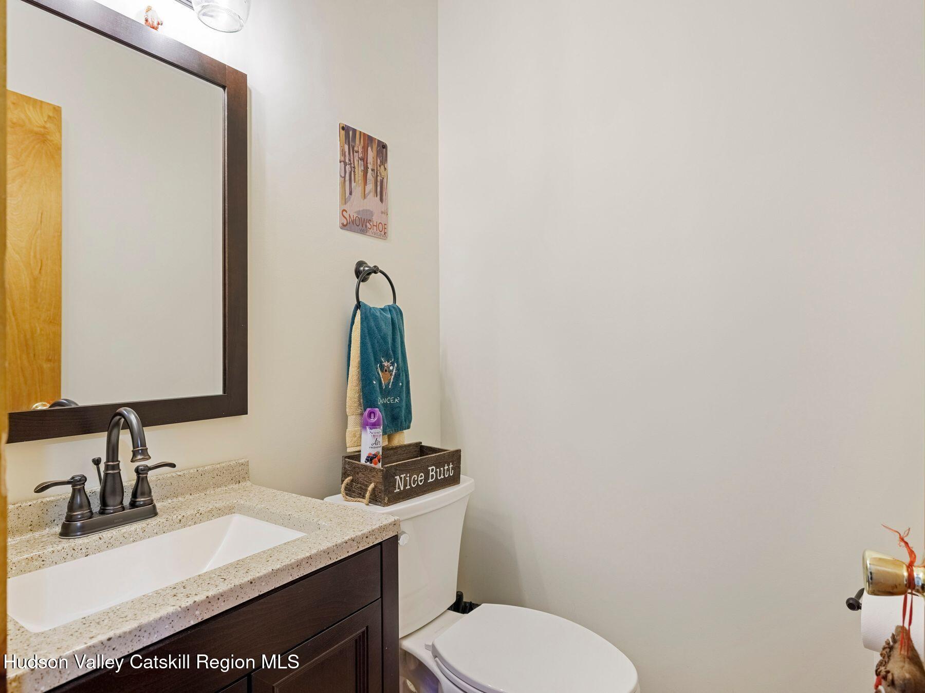 55 Windham Ridge Road, Unit 15H Windham, NY 12496 - Photo 14 of 34 a bathroom with a sink vanity mirror and toilet