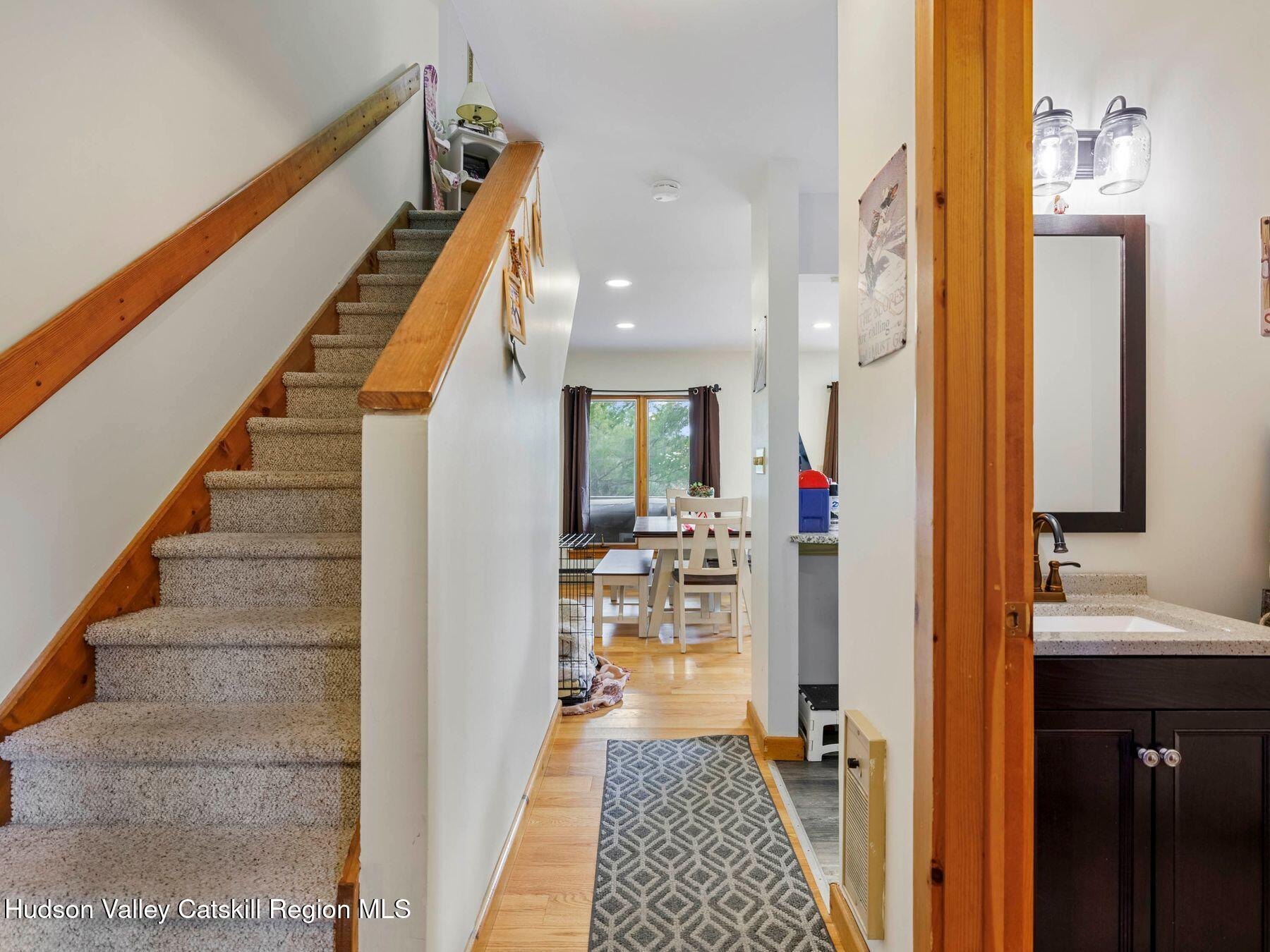 55 Windham Ridge Road, Unit 15H Windham, NY 12496 - Photo 16 of 34 a view of a hallway with wooden floor and staircase