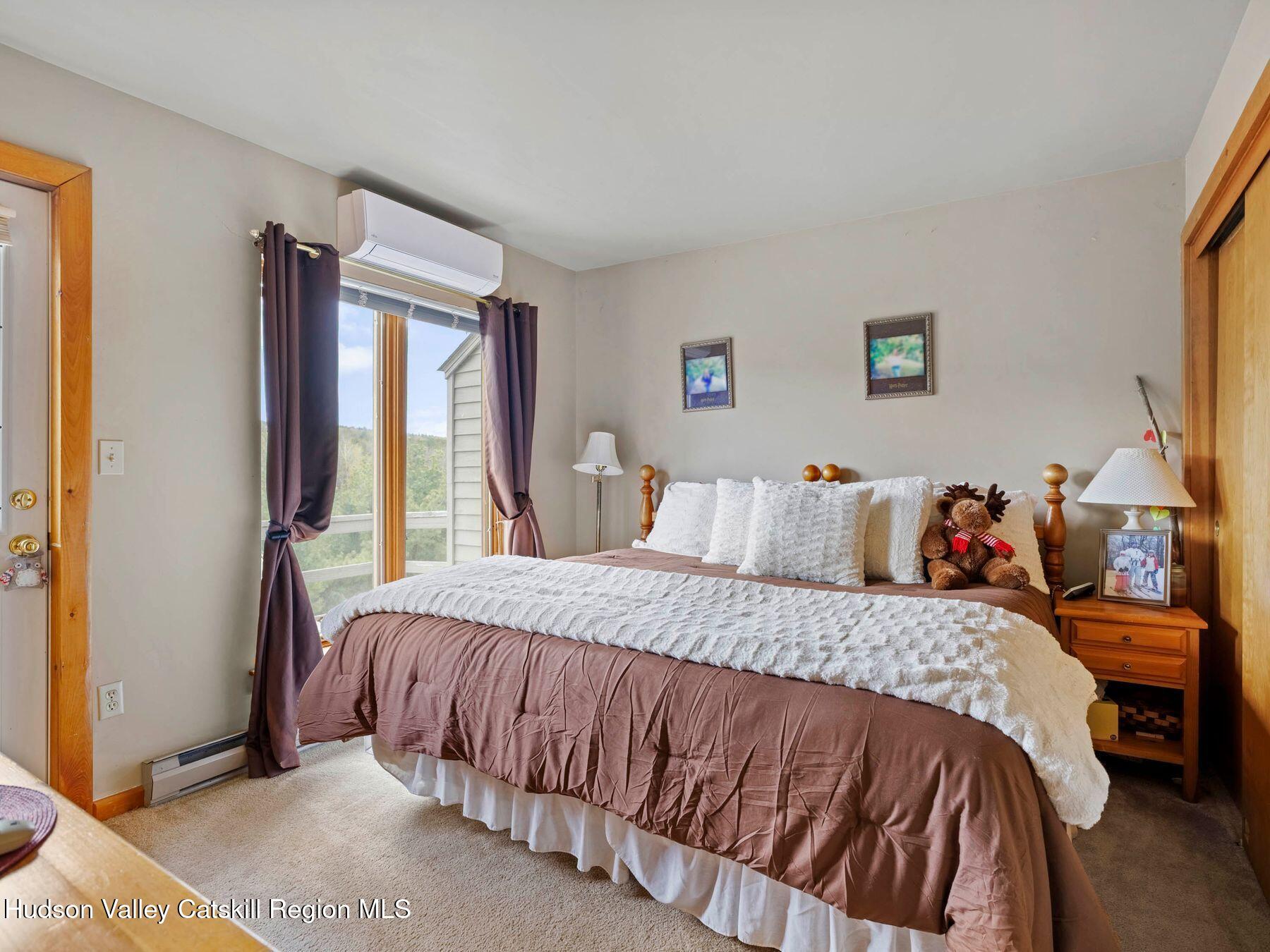 55 Windham Ridge Road, Unit 15H Windham, NY 12496 - Photo 17 of 34 a bedroom with a bed and a window
