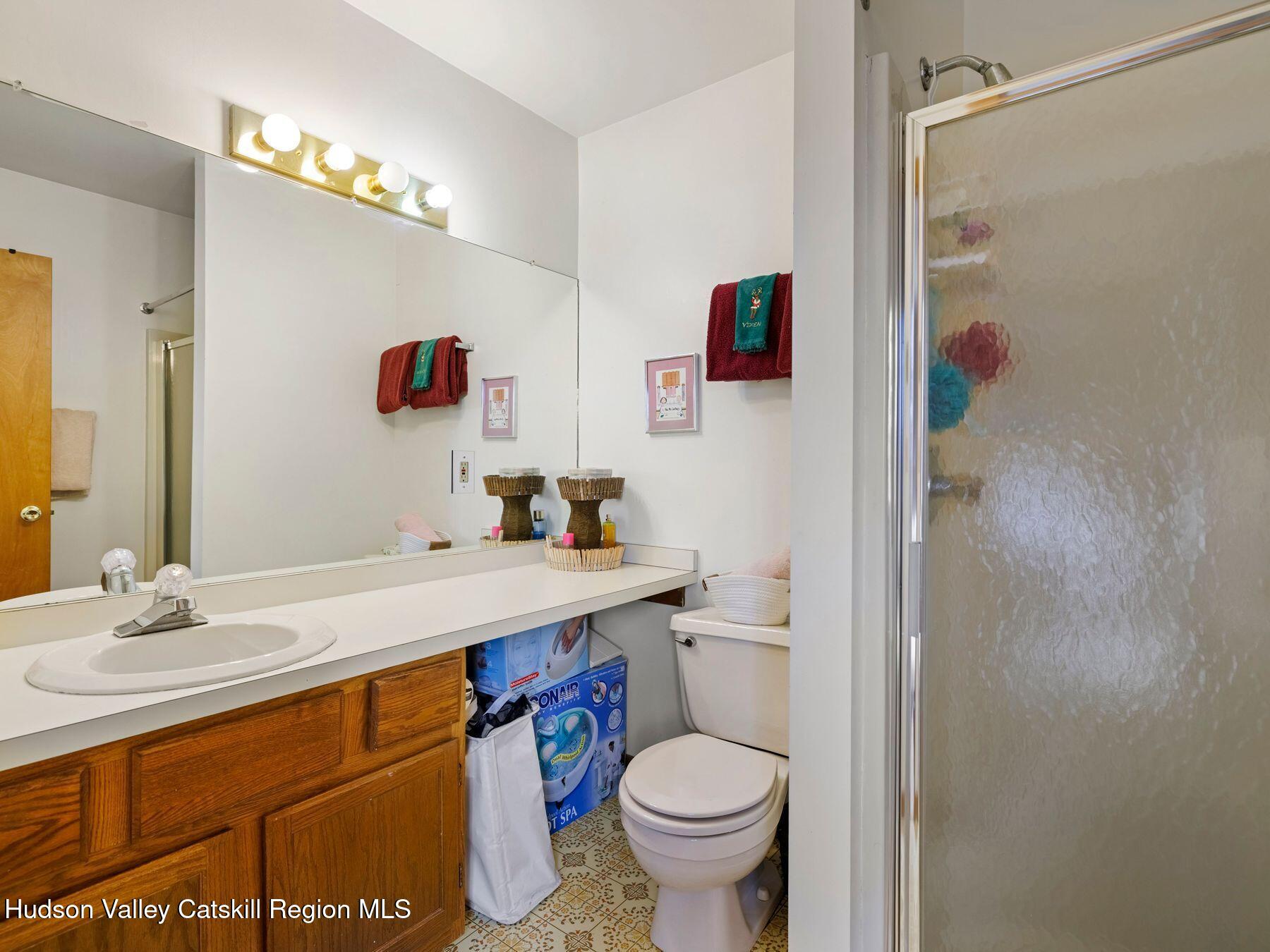 55 Windham Ridge Road, Unit 15H Windham, NY 12496 - Photo 19 of 34 a bathroom with a sink a toilet and shower
