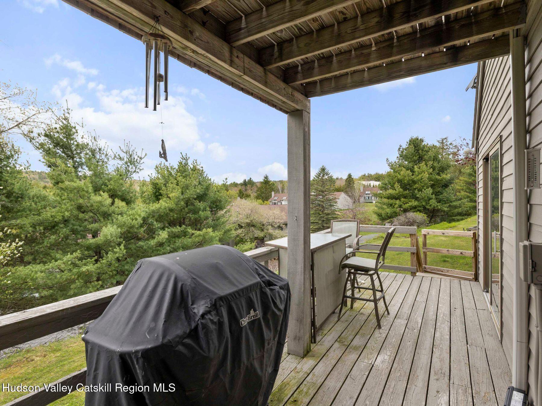 55 Windham Ridge Road, Unit 15H Windham, NY 12496 - Photo 25 of 34 a view of balcony with a table and chairs