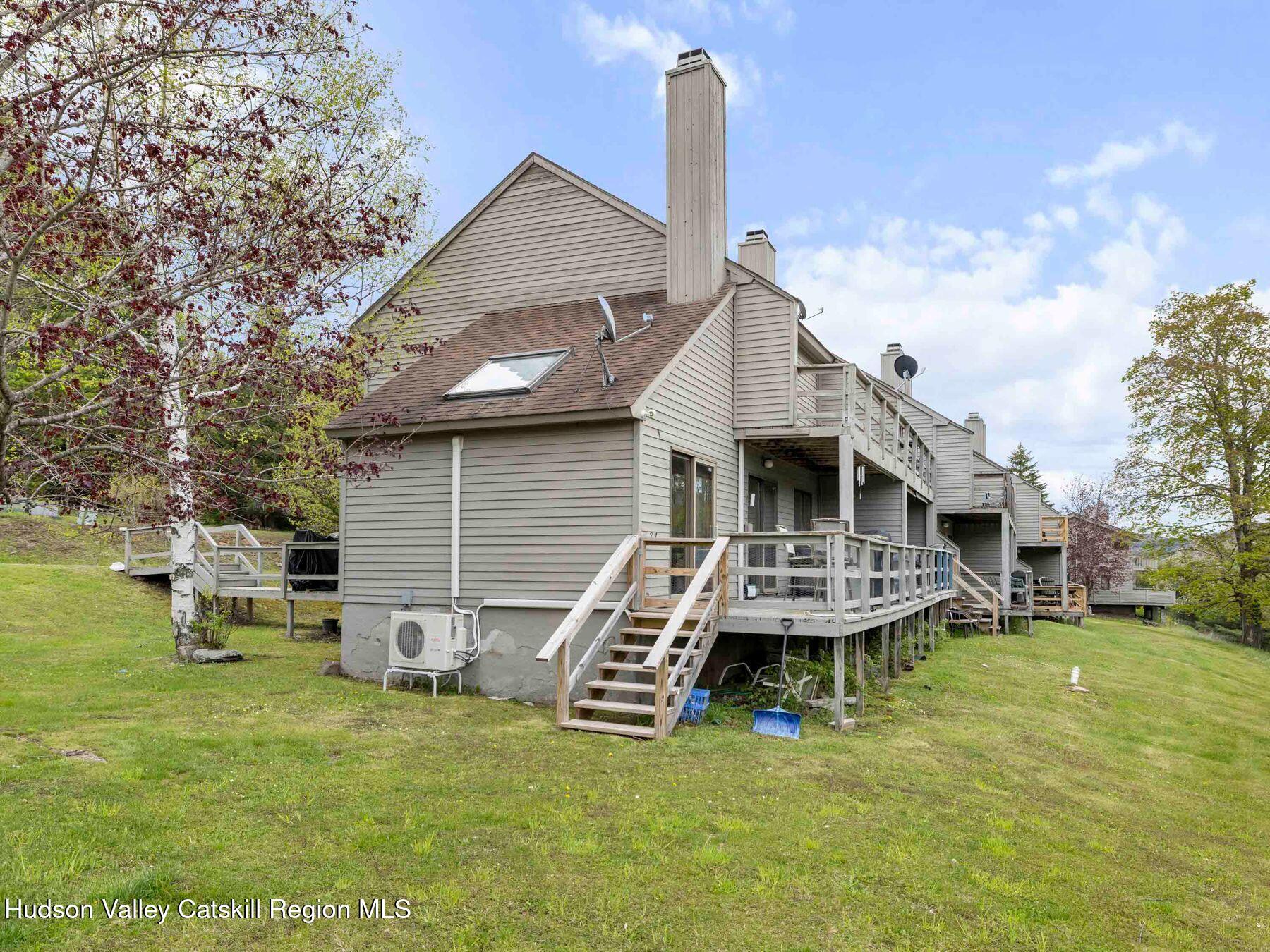 55 Windham Ridge Road, Unit 15H Windham, NY 12496 - Photo 30 of 34 a view of a house with a yard porch and sitting area