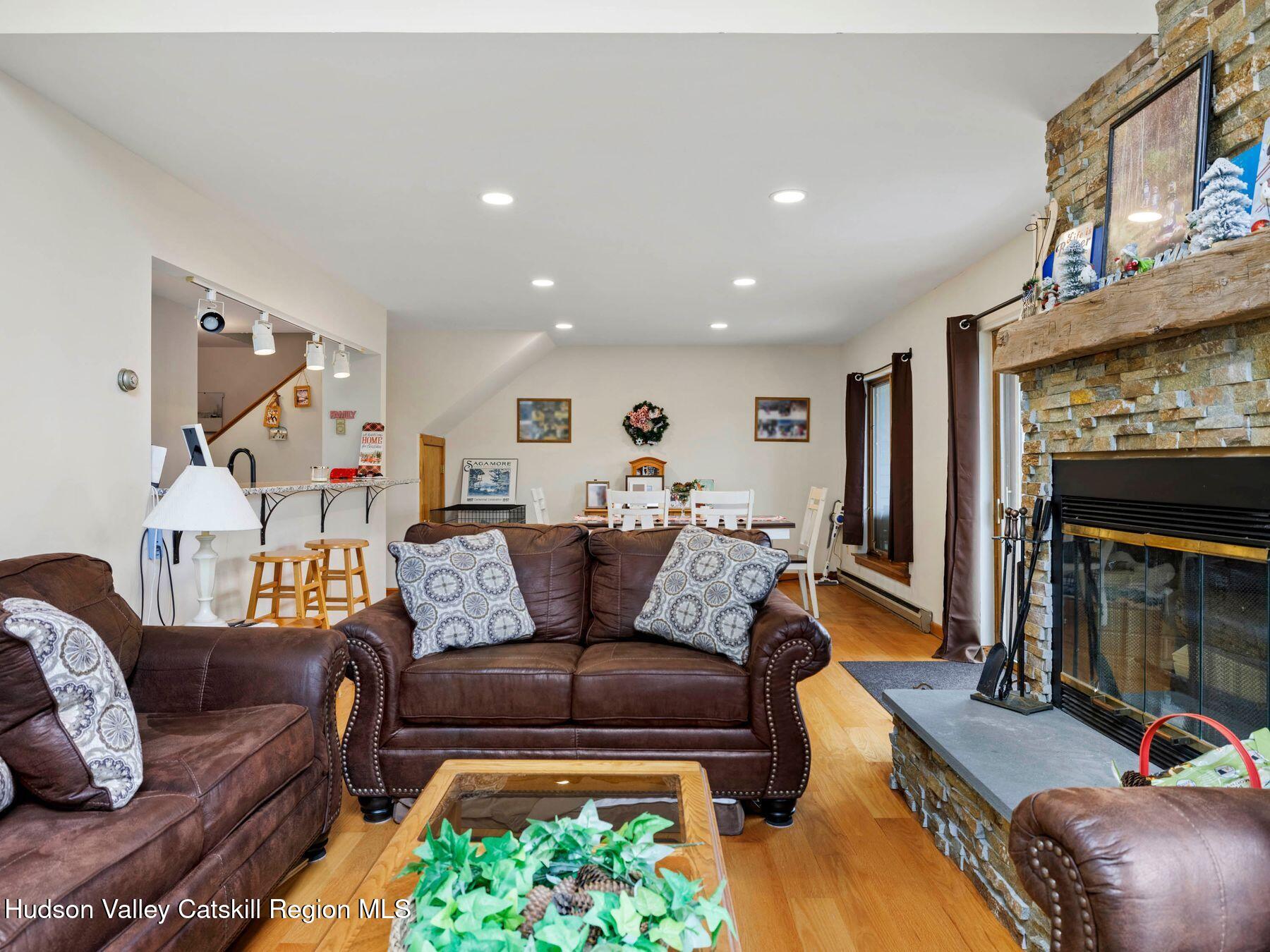 55 Windham Ridge Road, Unit 15H Windham, NY 12496 - Photo 5 of 34 a living room with furniture and a fireplace
