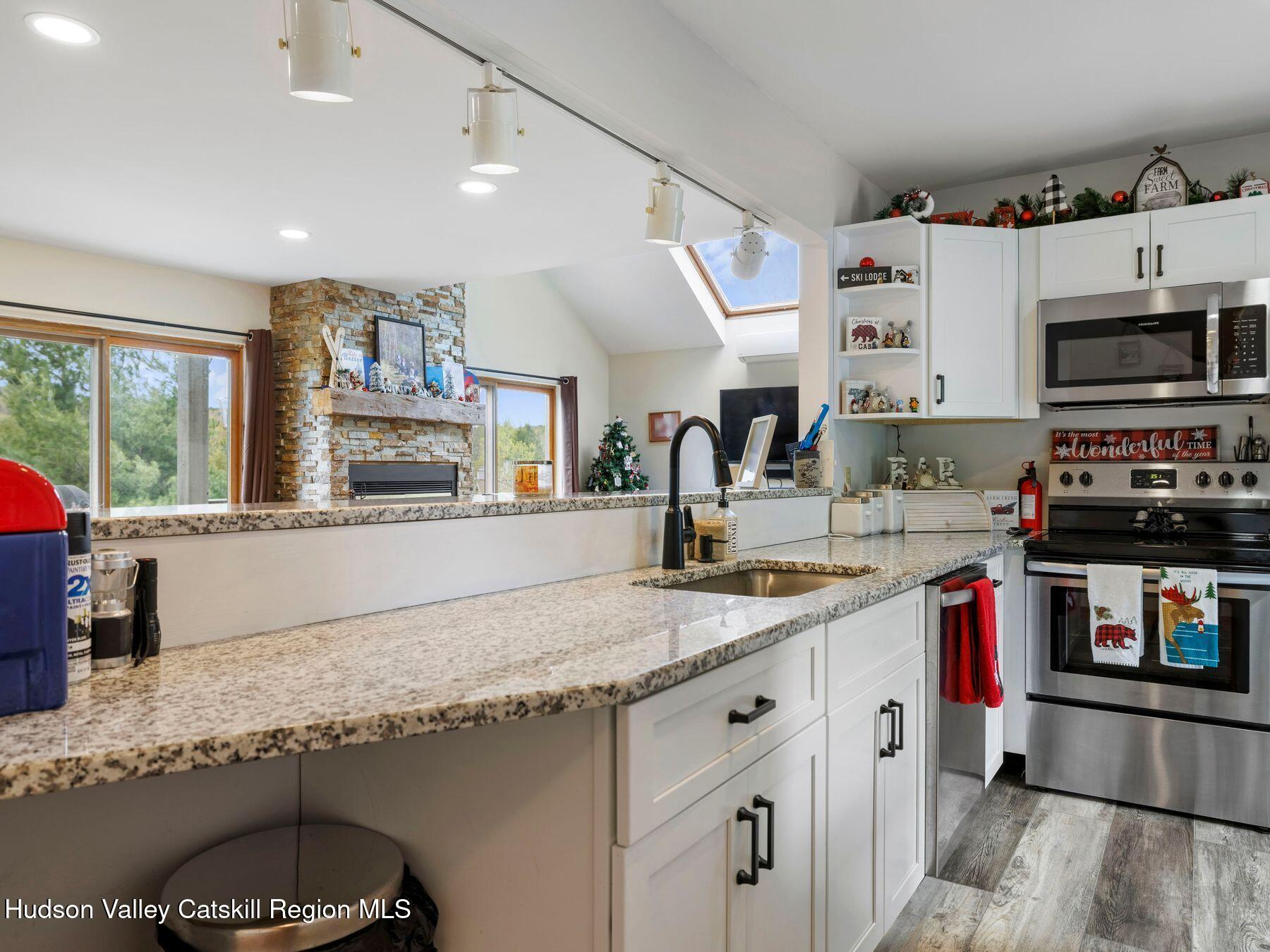 55 Windham Ridge Road, Unit 15H Windham, NY 12496 - Photo 9 of 34 a kitchen with granite countertop a stove and a sink