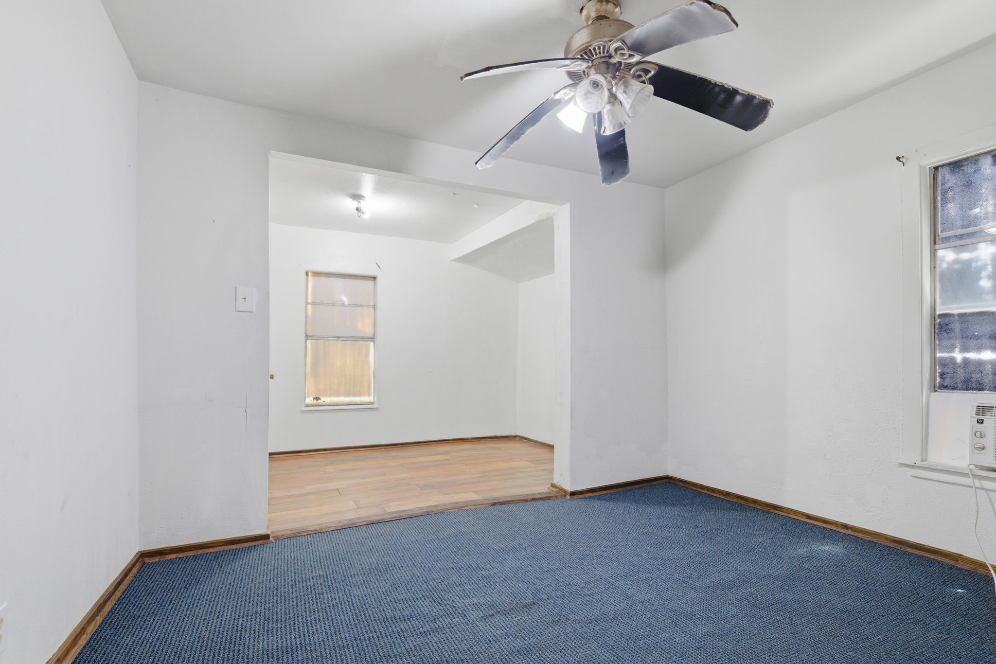 2423 Chamberlain Street Houston, TX 77093 - Photo 11 of 14 an empty room with windows and fan