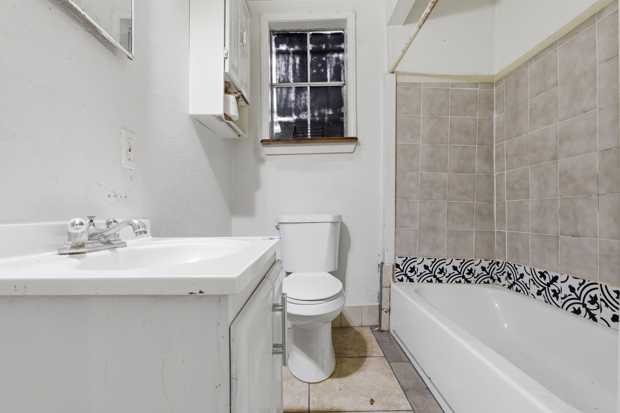2423 Chamberlain Street Houston, TX 77093 - Photo 12 of 14 a bathroom with a sink a toilet and shower
