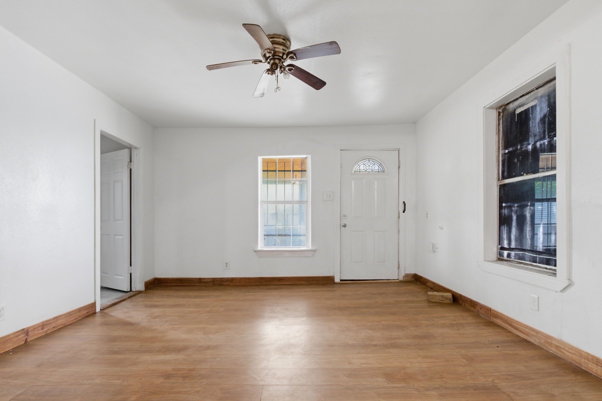 2423 Chamberlain Street Houston, TX 77093 - Photo 6 of 14 wooden floor in an empty room with a window