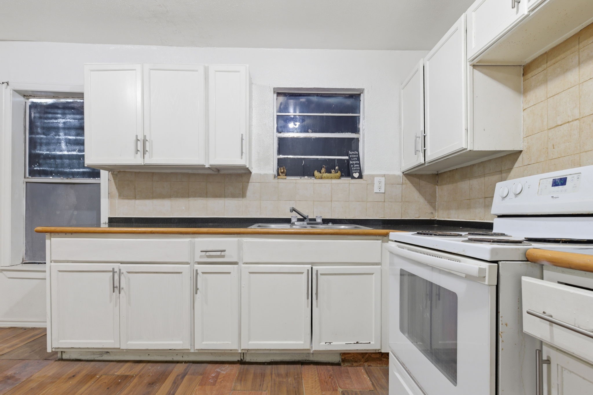 2423 Chamberlain Street Houston, TX 77093 - Photo 8 of 14 a kitchen with white cabinets and white appliances