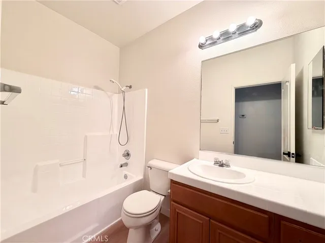 a bathroom with a sink toilet vanity and shower