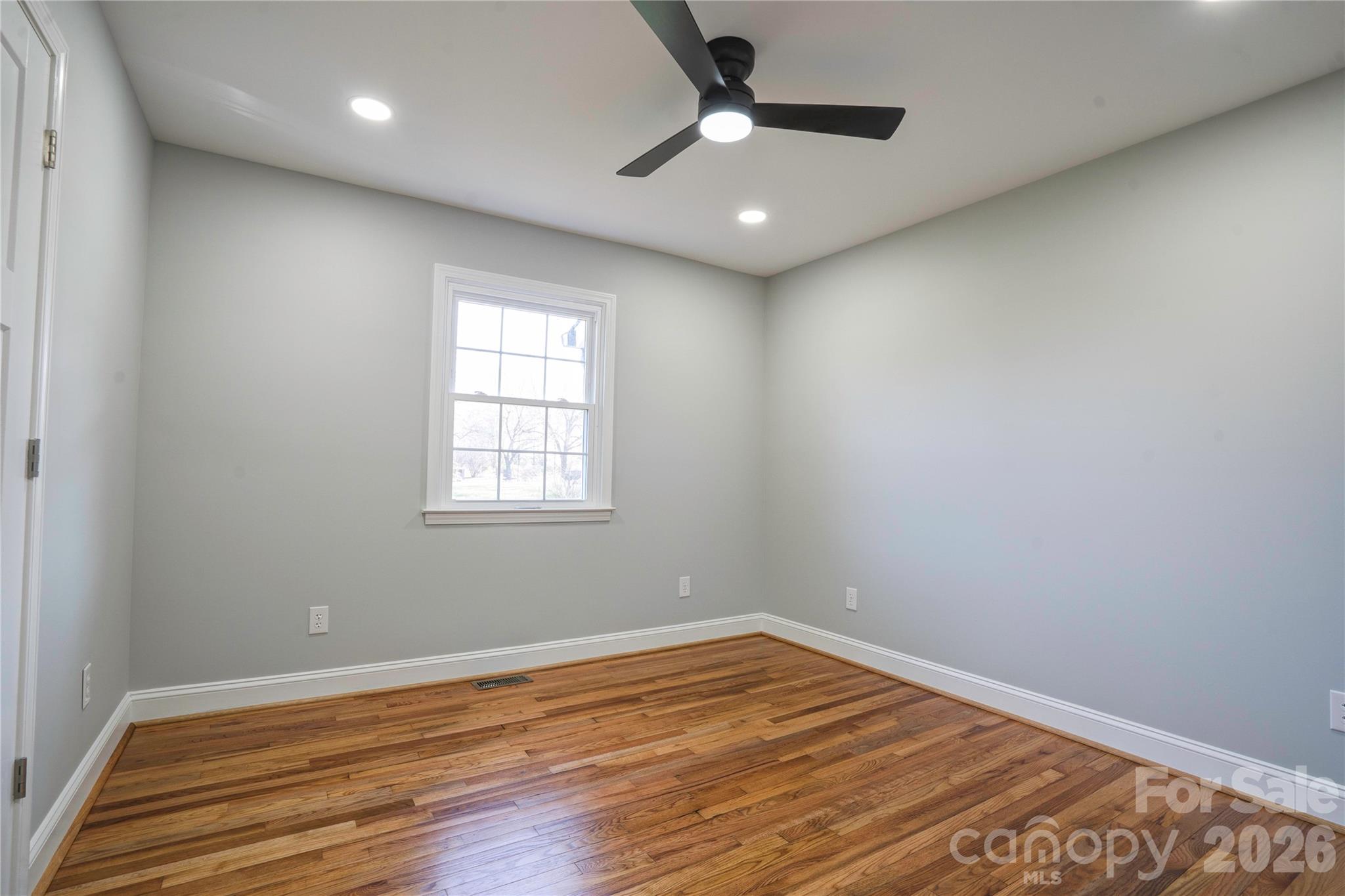 2822 Bettis Road Grover, NC 28073 - Photo 22 of 32 an empty room with wooden floor and windows