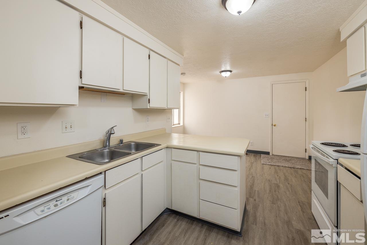 6885 Lotus Street Reno, NV 89506 - Photo 3 of 11 a kitchen with white cabinets and sink