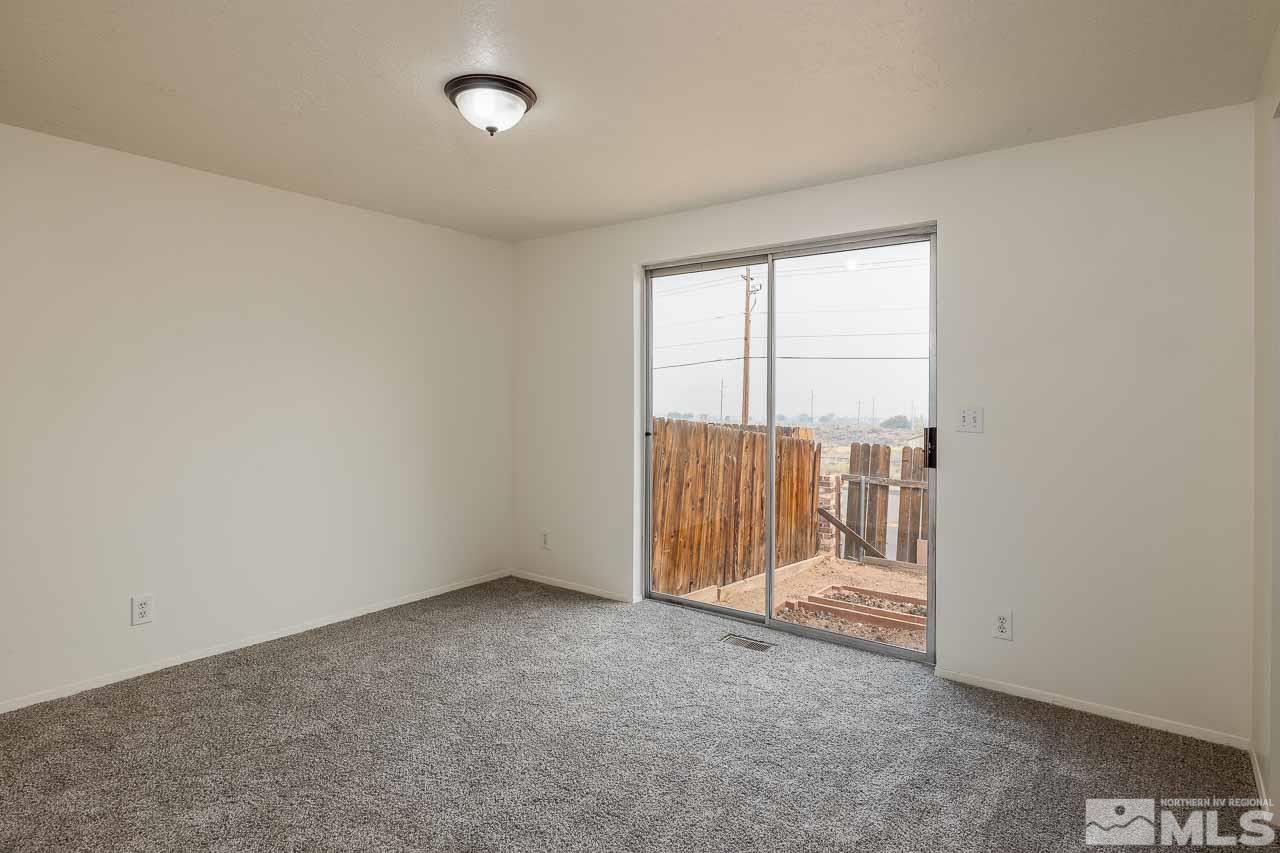 6885 Lotus Street Reno, NV 89506 - Photo 6 of 11 an empty room with sliding door and mountain view